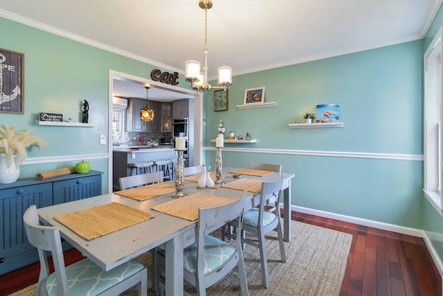 69 Leverett Ave, Revere, MA 02151 - dining area featuring dark wood-style flooring, crown molding, a chandelier, and baseboards