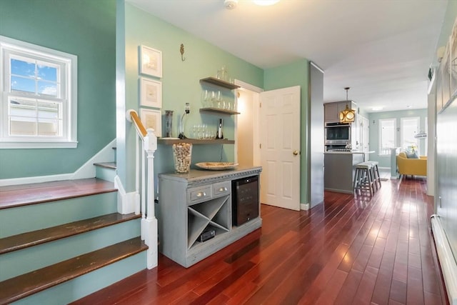 69 Leverett Ave, Revere, MA 02151 - kitchen featuring baseboard heating, wine cooler, dark wood finished floors, open shelves, and baseboards