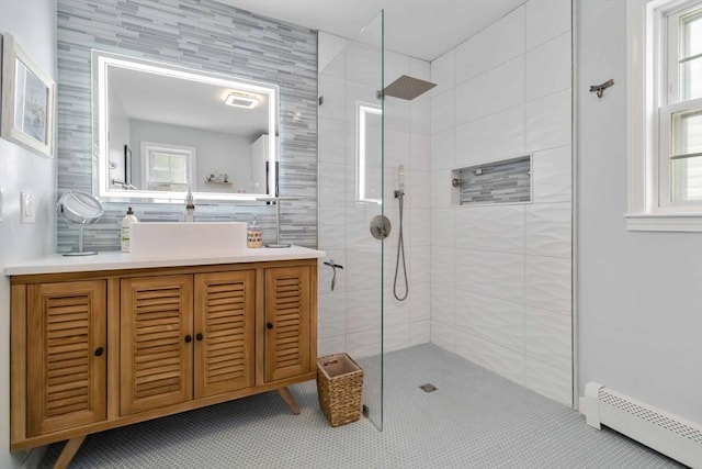 69 Leverett Ave, Revere, MA 02151 - full bathroom with a baseboard radiator, walk in shower, vanity, healthy amount of natural light, and tile walls