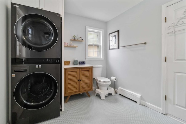 69 Leverett Ave, Revere, MA 02151 - laundry room with stacked washer / drying machine, a baseboard radiator, baseboards, and carpet floors