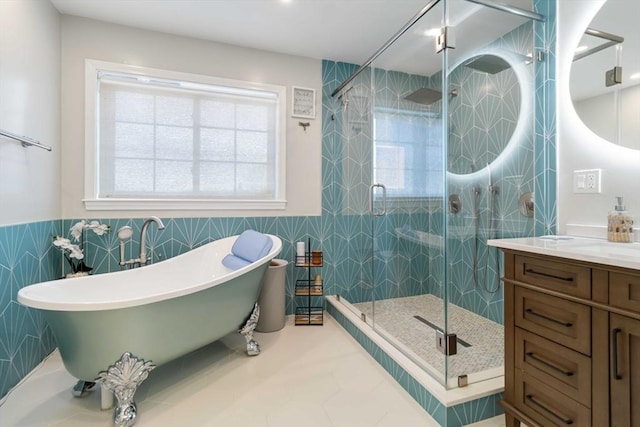 69 Leverett Ave, Revere, MA 02151 - full bathroom with a freestanding bath, vanity, a shower stall, tile walls, and a wainscoted wall