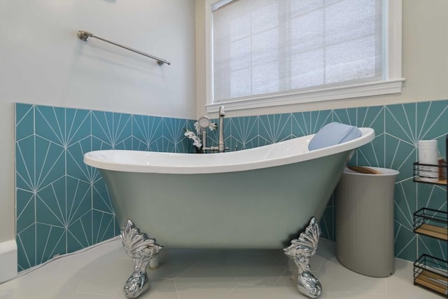 69 Leverett Ave, Revere, MA 02151 - bathroom featuring tile walls, a freestanding bath, plenty of natural light, and wainscoting
