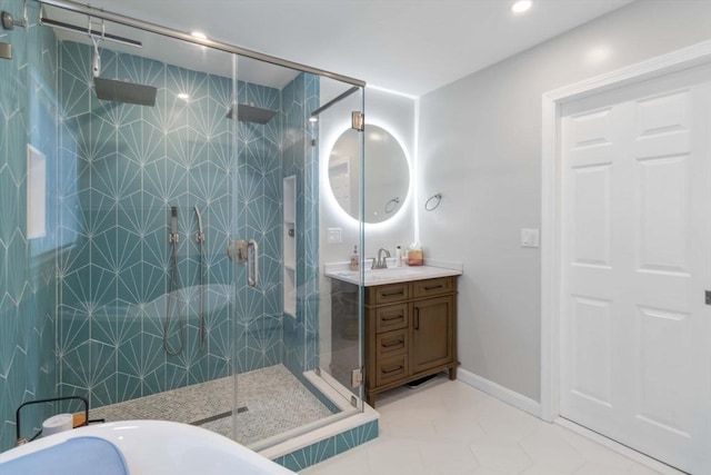 69 Leverett Ave, Revere, MA 02151 - bathroom with a stall shower, vanity, a soaking tub, tile patterned floors, and baseboards