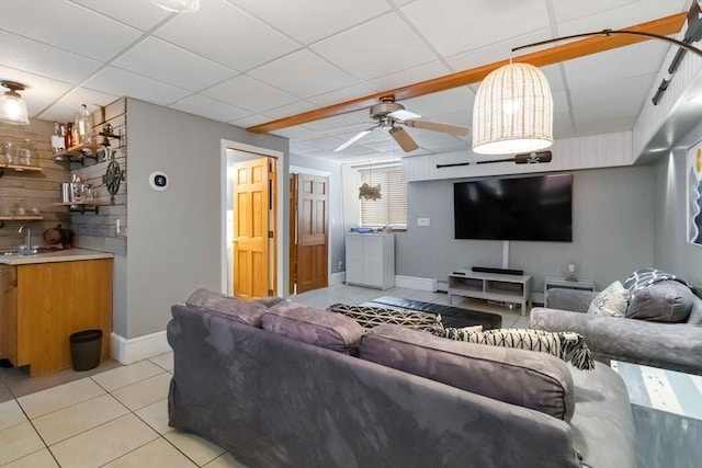 69 Leverett Ave, Revere, MA 02151 - living room with light tile patterned flooring, ceiling fan, baseboards, and a paneled ceiling