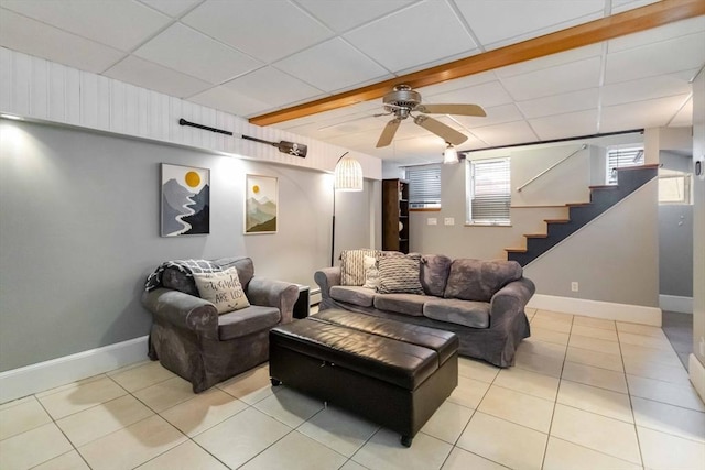 69 Leverett Ave, Revere, MA 02151 - living room featuring tile patterned flooring, baseboards, a paneled ceiling, stairs, and ceiling fan