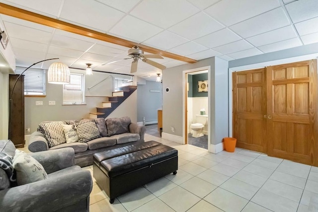 69 Leverett Ave, Revere, MA 02151 - living area featuring stairs, light tile patterned flooring, a drop ceiling, baseboards, and a ceiling fan