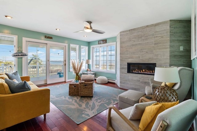 69 Leverett Ave, Revere, MA 02151 - living room with a ceiling fan, a baseboard radiator, a tiled fireplace, wood finished floors, and recessed lighting
