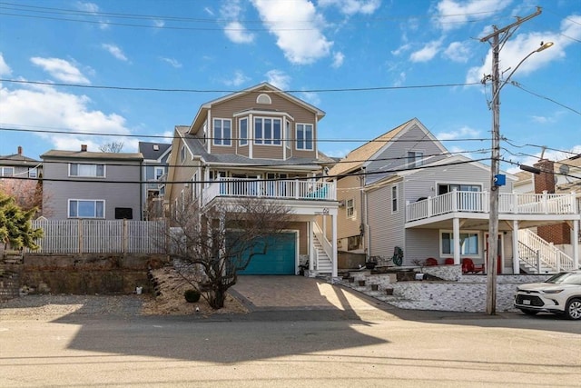 69 Leverett Ave, Revere, MA 02151 - view of front of home featuring stairway, driveway, and an attached garage
