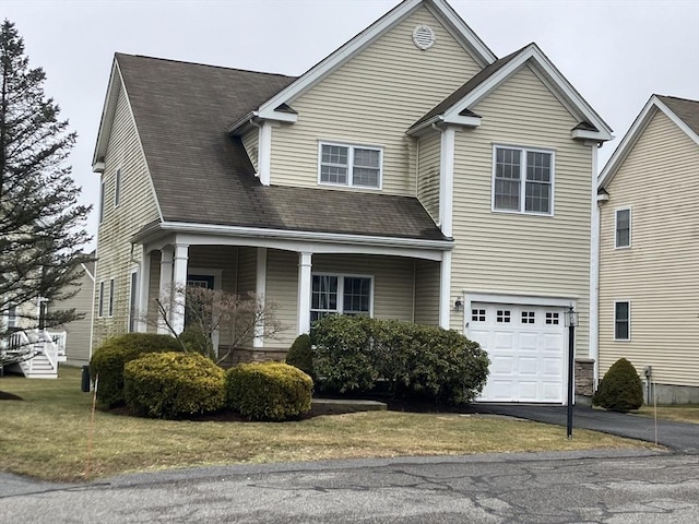 traditional home with aphalt driveway and an attached garage