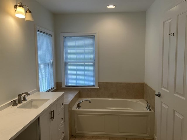 full bath featuring recessed lighting, a garden tub, vanity, and tile patterned floors