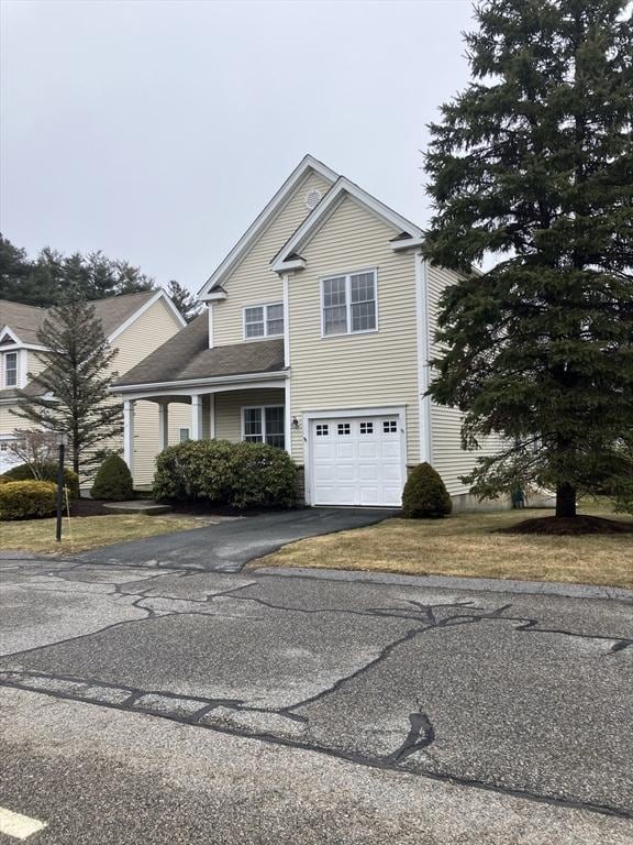 traditional-style home with driveway and an attached garage