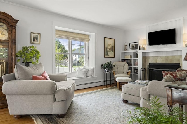 3 Roosevelt Pl, Newburyport, MA 01950 - living room with a baseboard heating unit, wood finished floors, a fireplace, and ornamental molding