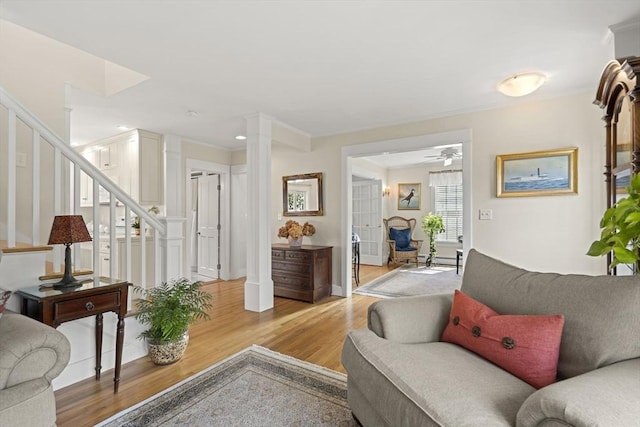 3 Roosevelt Pl, Newburyport, MA 01950 - living area with stairs, light wood finished floors, ceiling fan, baseboards, and ornate columns