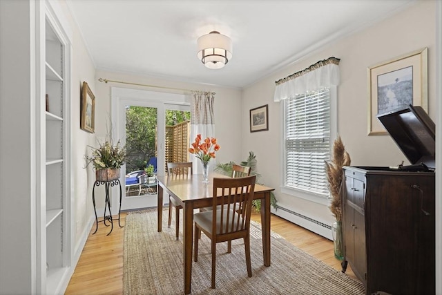 3 Roosevelt Pl, Newburyport, MA 01950 - dining space with a baseboard heating unit, light wood-type flooring, and ornamental molding