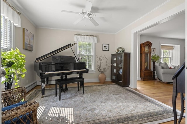 3 Roosevelt Pl, Newburyport, MA 01950 - living area with wood finished floors, crown molding, ceiling fan, baseboards, and a baseboard radiator
