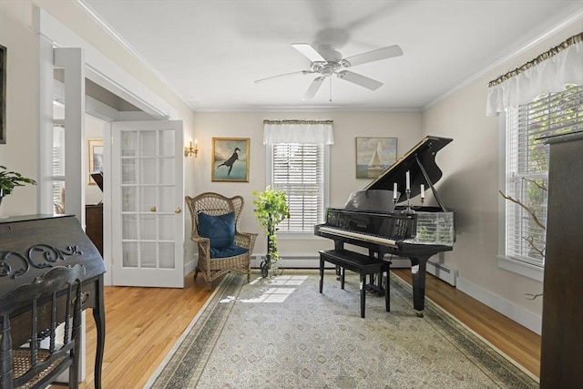 3 Roosevelt Pl, Newburyport, MA 01950 - living area with wood finished floors, crown molding, a ceiling fan, baseboards, and french doors