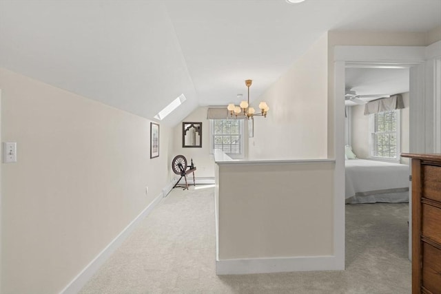 3 Roosevelt Pl, Newburyport, MA 01950 - corridor featuring light colored carpet, a chandelier, lofted ceiling, baseboards, and a skylight