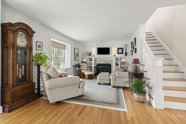 3 Roosevelt Pl, Newburyport, MA 01950 - living room with stairway, light wood finished floors, and a tile fireplace