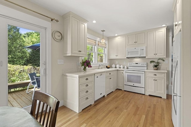 3 Roosevelt Pl, Newburyport, MA 01950 - kitchen with white appliances, light countertops, light wood-style floors, a sink, and recessed lighting