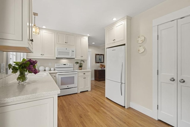 3 Roosevelt Pl, Newburyport, MA 01950 - kitchen with white appliances, light wood finished floors, light countertops, recessed lighting, and baseboards