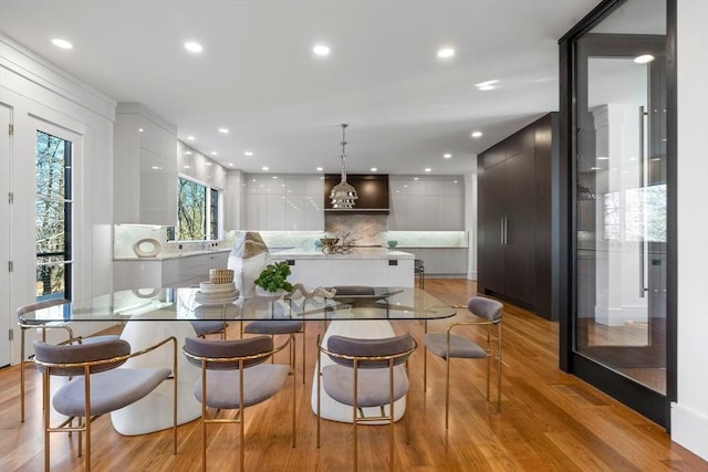 dining space with recessed lighting and light wood finished floors