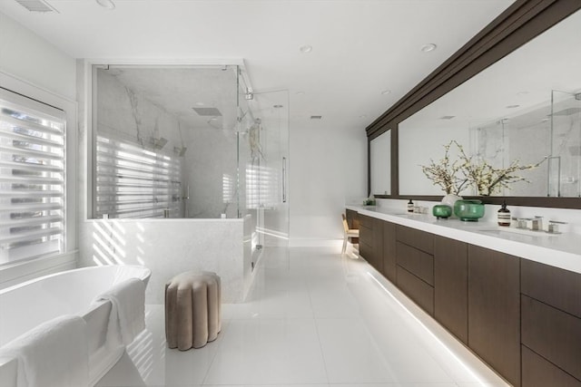 full bathroom featuring tile patterned flooring, a sink, a marble finish shower, and double vanity