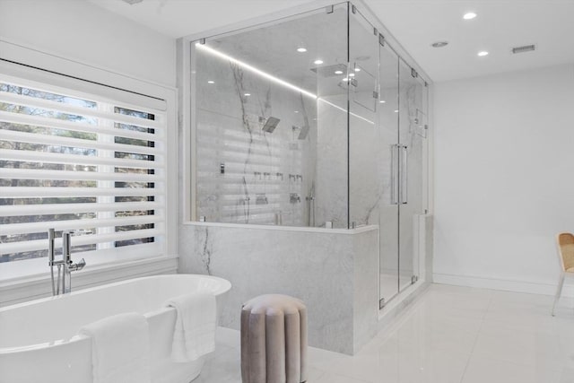 full bathroom with a freestanding tub, recessed lighting, visible vents, baseboards, and a marble finish shower