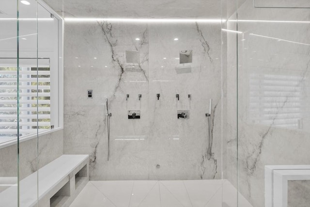 full bath with a marble finish shower