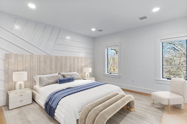 bedroom with light wood finished floors, baseboards, visible vents, and recessed lighting