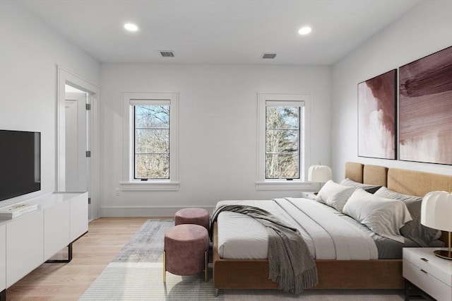 bedroom with baseboards, visible vents, light wood-style flooring, and recessed lighting