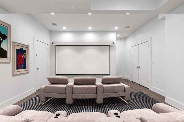 cinema room with baseboards, visible vents, wood finished floors, and recessed lighting