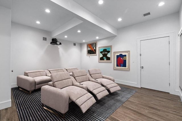 home theater room with baseboards, visible vents, dark wood-style flooring, and recessed lighting