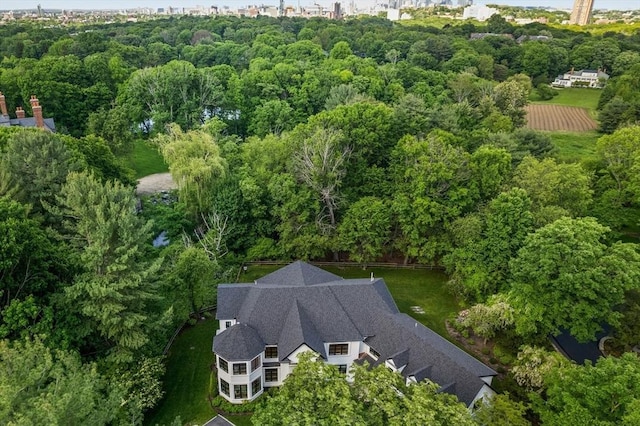 birds eye view of property featuring a view of trees