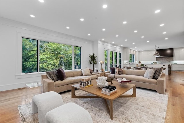 living area with light wood-type flooring, visible vents, and recessed lighting