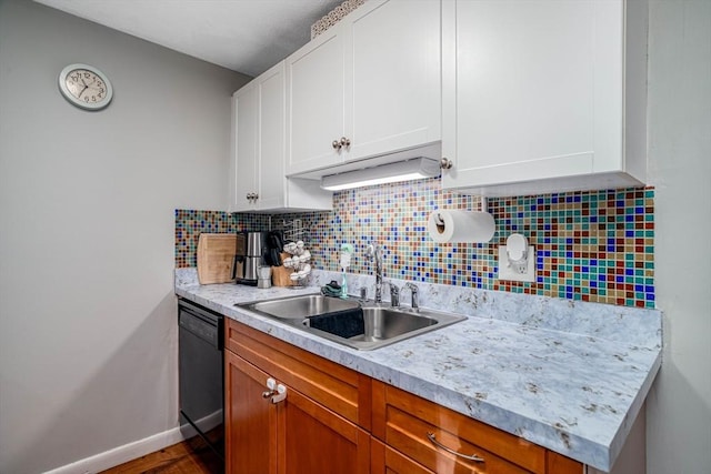 kitchen featuring sink, backsplash, white cabinets, and black dishwasher