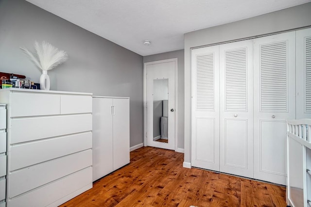 unfurnished bedroom with light hardwood / wood-style floors and a closet