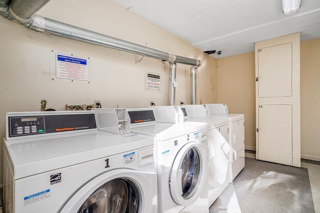 clothes washing area with washer and clothes dryer