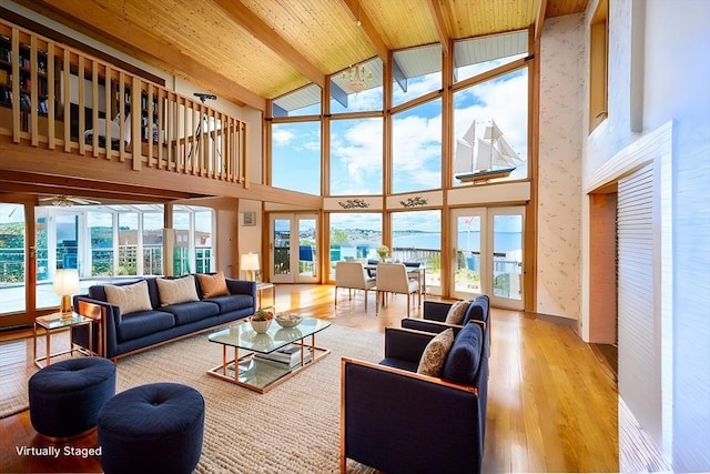 living area featuring wood finished floors, wood ceiling, french doors, beam ceiling, and wallpapered walls