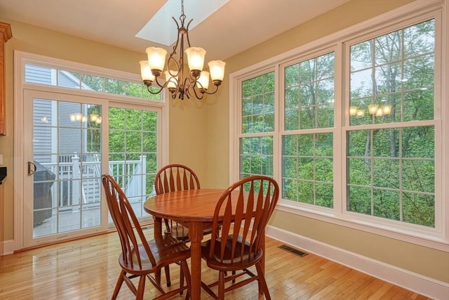 106 Willow Brook Dr Unit 106, Wayland, MA 01778 - dining room featuring a chandelier, light wood finished floors, and plenty of natural light