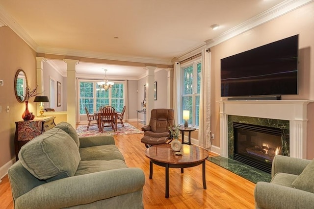 106 Willow Brook Dr Unit 106, Wayland, MA 01778 - living room with ornate columns, crown molding, light wood-type flooring, and a premium fireplace