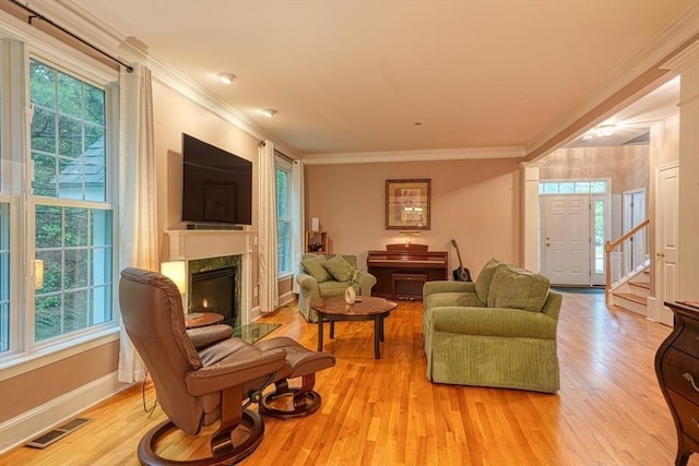 106 Willow Brook Dr Unit 106, Wayland, MA 01778 - living room featuring healthy amount of natural light, light wood-type flooring, a premium fireplace, ornamental molding, and stairway