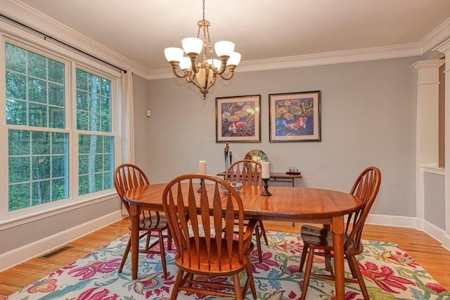 106 Willow Brook Dr Unit 106, Wayland, MA 01778 - dining area with a chandelier, healthy amount of natural light, light wood-style floors, and ornamental molding