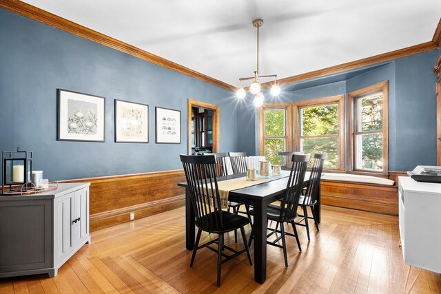 30 Welles Ave Unit 2, Boston, MA 02124 - dining area featuring ornamental molding, light wood-type flooring, a wainscoted wall, and a chandelier