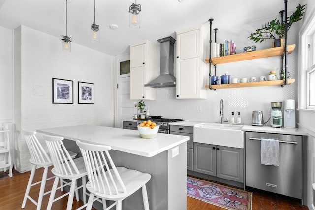 30 Welles Ave Unit 2, Boston, MA 02124 - kitchen featuring appliances with stainless steel finishes, wall chimney range hood, gray cabinetry, a sink, and dark wood-style flooring