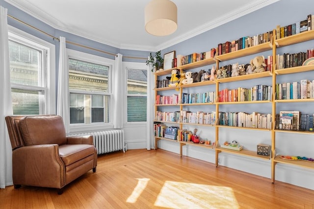 30 Welles Ave Unit 2, Boston, MA 02124 - living area with radiator heating unit, wood finished floors, and crown molding