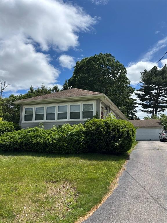29 Bower Ave, Brockton, MA 02301 - view of side of home with a yard and a garage