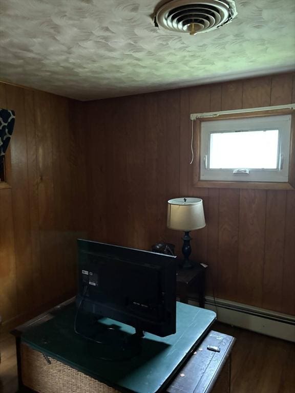 29 Bower Ave, Brockton, MA 02301 - office space featuring a baseboard radiator, wooden walls, and dark wood-type flooring