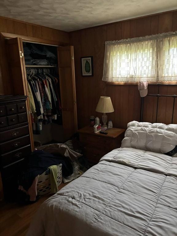29 Bower Ave, Brockton, MA 02301 - bedroom featuring a closet, wood finished floors, and wooden walls