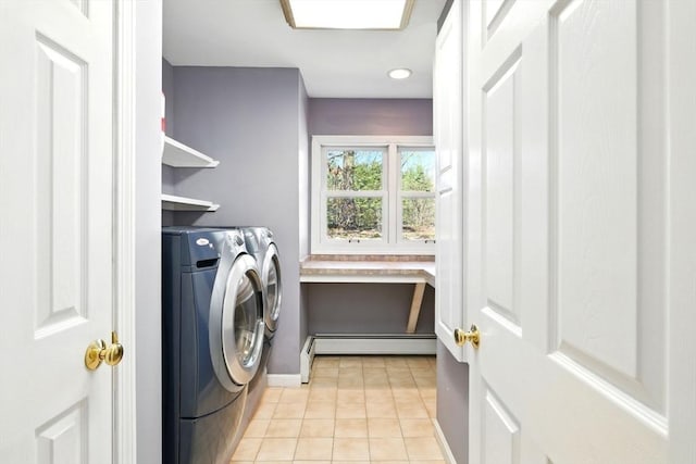 laundry room with light tile patterned floors, a baseboard radiator, laundry area, and independent washer and dryer