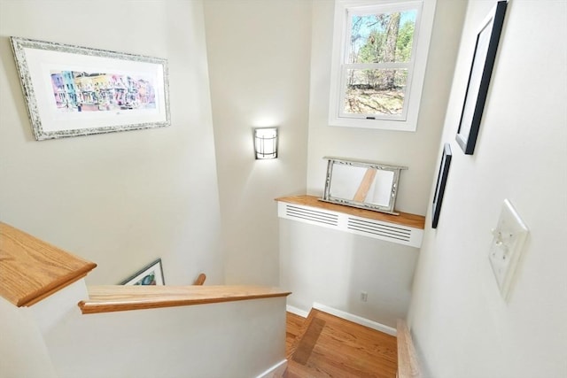 stairs with baseboards and wood finished floors